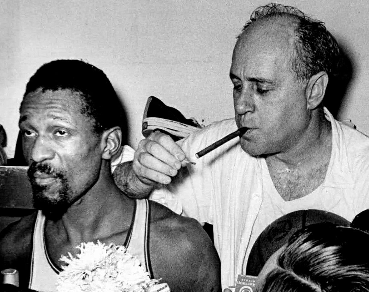 Boston Celtics center Bill Russell next to head coach Red Auerbach after winning the 1966 NBA Finals.
